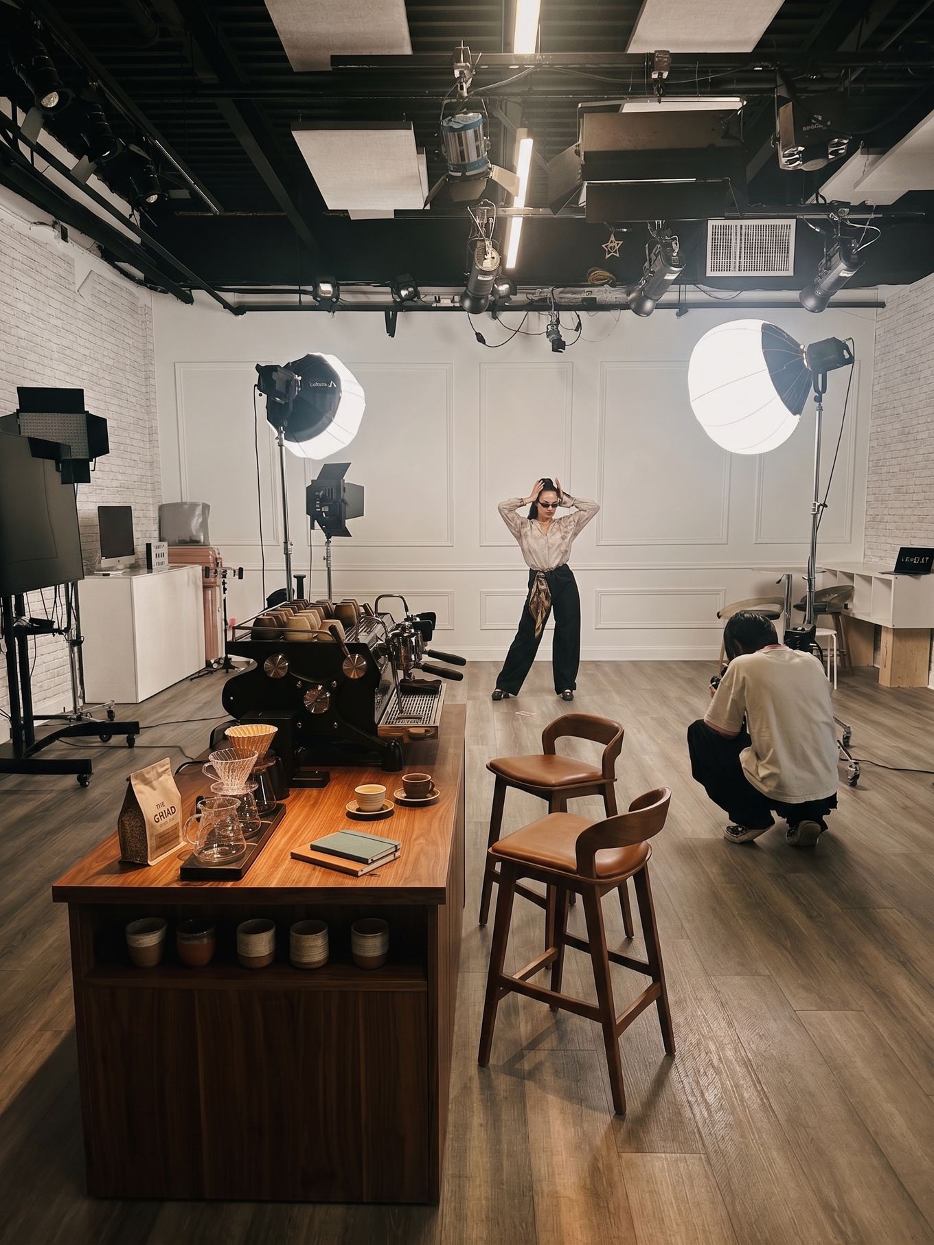 Wide view of the studio with a wooden coffee island and bar stools