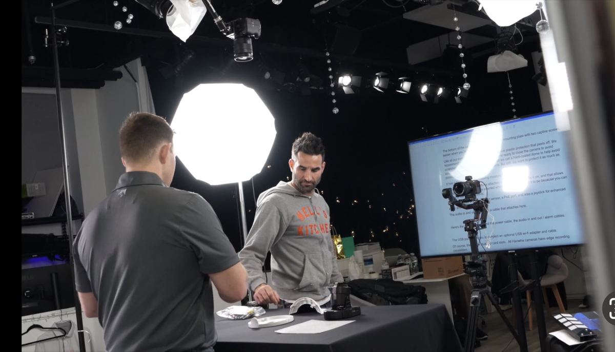 Crew reviewing a shot with softbox and teleprompter